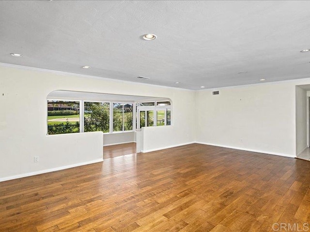 1051 La Reina, San Marcos, CA 92078 - empty room with crown molding, wood finished floors, baseboards, and recessed lighting