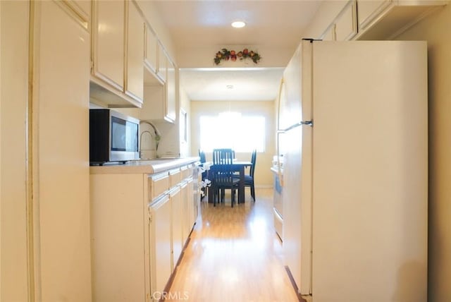 570 W Stocker St Unit 202, Glendale, CA 91202 - kitchen featuring freestanding refrigerator, light wood-style flooring, light countertops, and recessed lighting