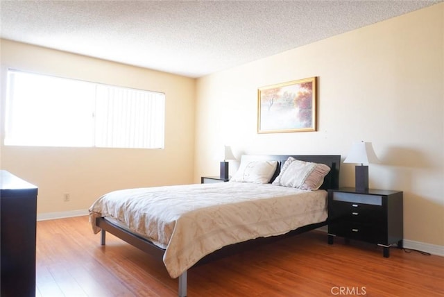 570 W Stocker St Unit 202, Glendale, CA 91202 - bedroom with wood finished floors, baseboards, and a textured ceiling