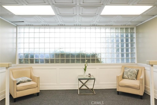 570 W Stocker St Unit 202, Glendale, CA 91202 - living area featuring dark carpet, a decorative wall, and wainscoting