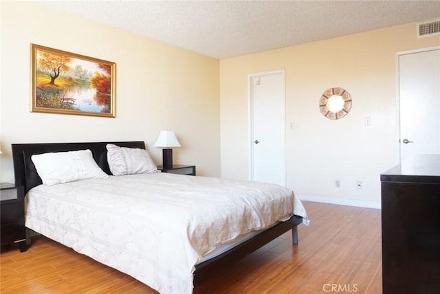 570 W Stocker St Unit 202, Glendale, CA 91202 - bedroom with wood finished floors, a textured ceiling, and baseboards
