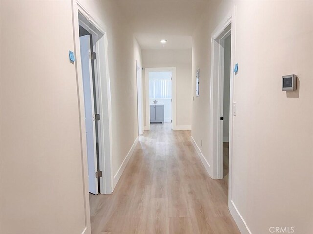 1051 W 18th St, Los Angeles, CA 90015 - hallway featuring light wood-type flooring and baseboards