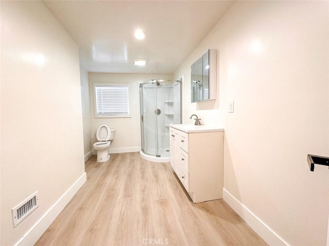 1051 W 18th St, Los Angeles, CA 90015 - bathroom with vanity, wood finished floors, a shower stall, and baseboards