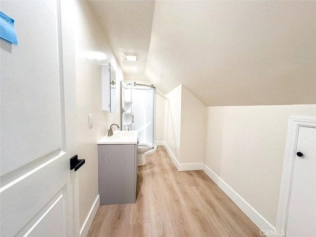 1051 W 18th St, Los Angeles, CA 90015 - bathroom with wood finished floors, a stall shower, lofted ceiling, baseboards, and toilet