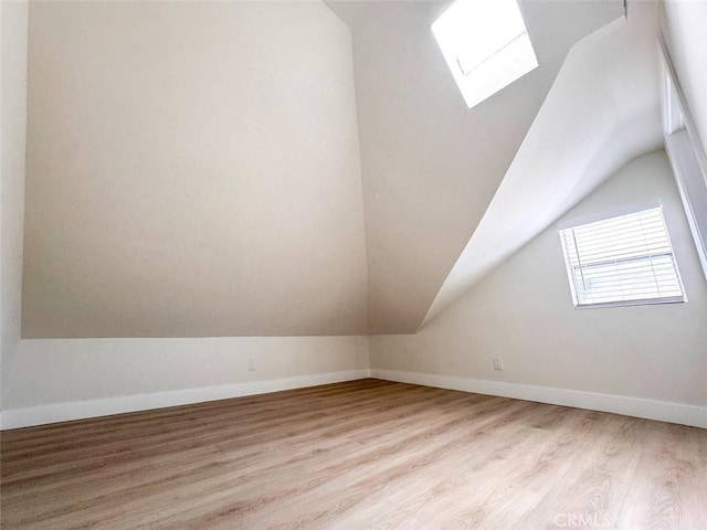 1051 W 18th St, Los Angeles, CA 90015 - bonus room with a skylight, vaulted ceiling, light wood finished floors, and baseboards