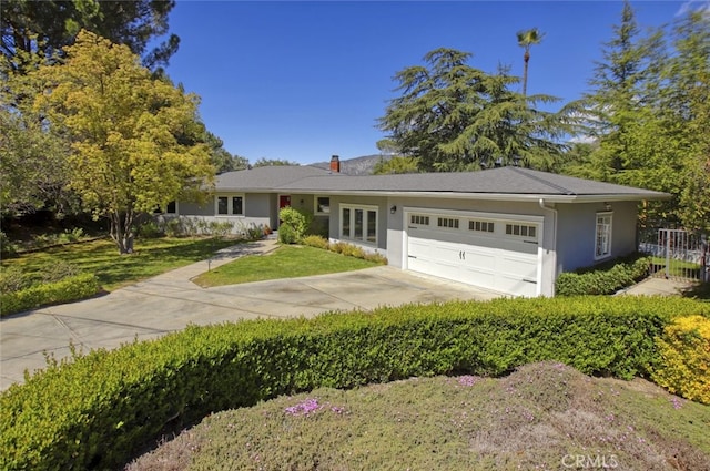 7235 Estepa Dr, Tujunga, CA 91042 - ranch-style house with an attached garage, stucco siding, a front yard, concrete driveway, and a chimney