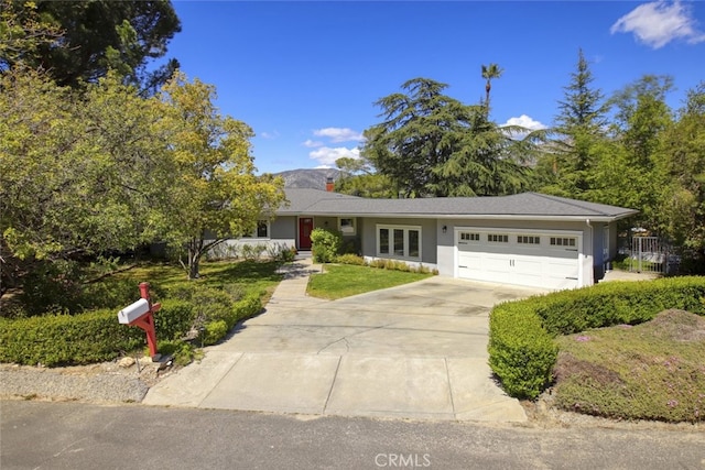 7235 Estepa Dr, Tujunga, CA 91042 - view of front facade featuring an attached garage, driveway, stucco siding, a front yard, and a chimney