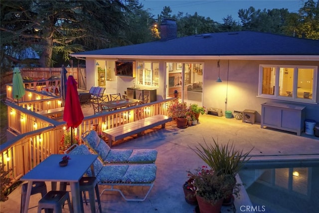 7235 Estepa Dr, Tujunga, CA 91042 - rear view of house featuring a patio, outdoor dining space, stucco siding, a chimney, and a hot tub