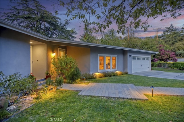 7235 Estepa Dr, Tujunga, CA 91042 - view of front of home with stucco siding, concrete driveway, a garage, and a front yard