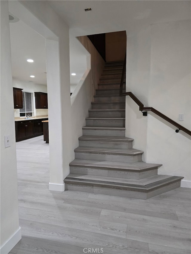 1416 Plaza Way, Perris, CA 92570 - stairway featuring baseboards, wood finished floors, and recessed lighting