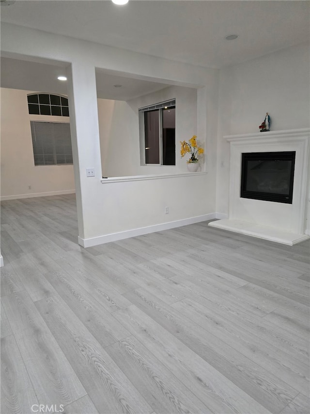 1416 Plaza Way, Perris, CA 92570 - unfurnished living room with wood finished floors, a glass covered fireplace, baseboards, and recessed lighting