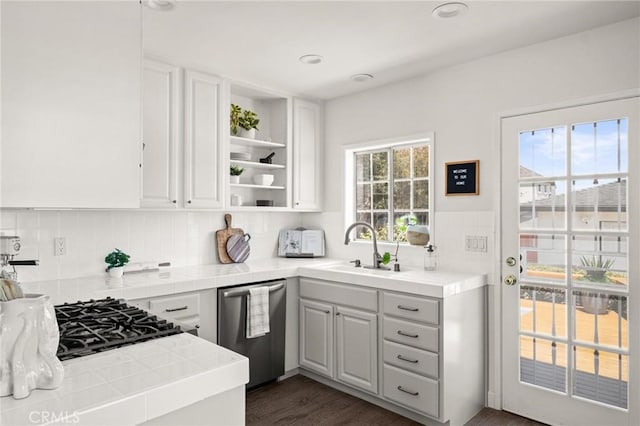 1108 Stanford Ave, Redondo Beach, CA 90278 - kitchen with stainless steel dishwasher, tile counters, a sink, open shelves, and white cabinetry