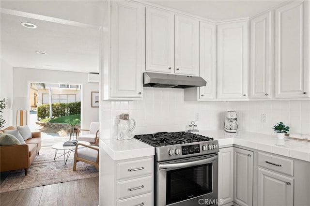 1108 Stanford Ave, Redondo Beach, CA 90278 - kitchen with gas range, under cabinet range hood, white cabinets, decorative backsplash, and recessed lighting