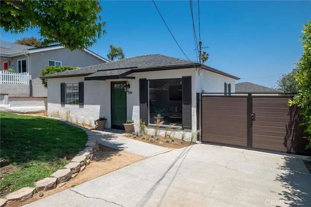 1108 Stanford Ave, Redondo Beach, CA 90278 - view of front of house with stucco siding, concrete driveway, an attached garage, and a gate