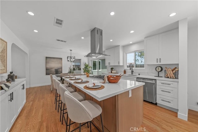1848 Lave Ave, Long Beach, CA 90815 - kitchen featuring island exhaust hood, dishwasher, a breakfast bar, light wood-type flooring, and recessed lighting
