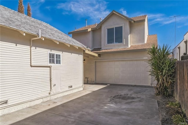 390 E 4th St, San Bernardino, CA 92410 - view of side of home featuring concrete driveway, an attached garage, roof with shingles, and stucco siding