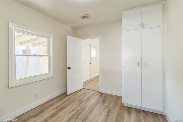 390 E 4th St, San Bernardino, CA 92410 - unfurnished bedroom featuring baseboards, light wood-type flooring, and a closet