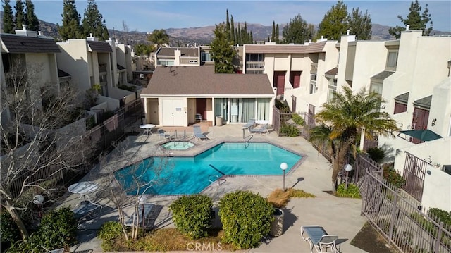 9950 Topanga Canyon Blvd Unit 5, Chatsworth, CA 91311 - back of property featuring a hot tub, a residential view, stucco siding, and a patio