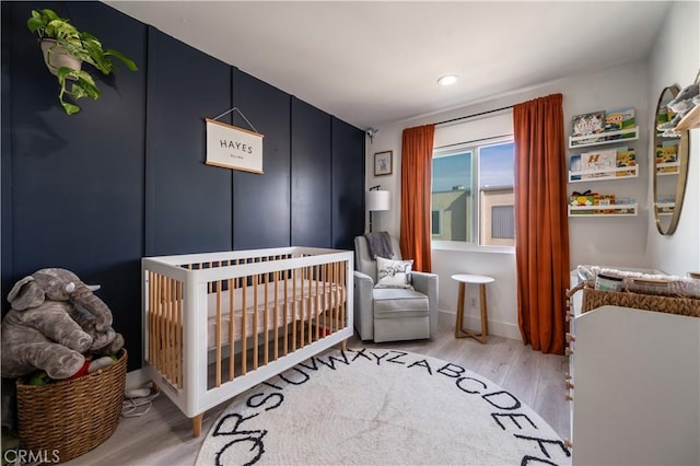 9950 Topanga Canyon Blvd Unit 5, Chatsworth, CA 91311 - bedroom with light wood-style floors, a nursery area, and recessed lighting