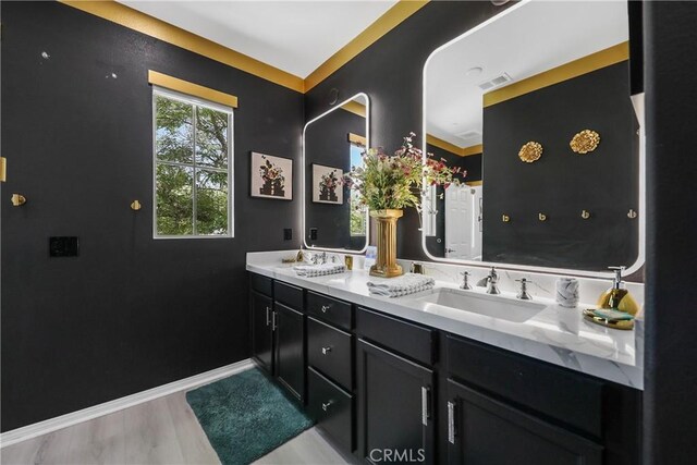 43228 Bacino Ct, Indio, CA 92203 - bathroom with double vanity, wood finished floors, and baseboards