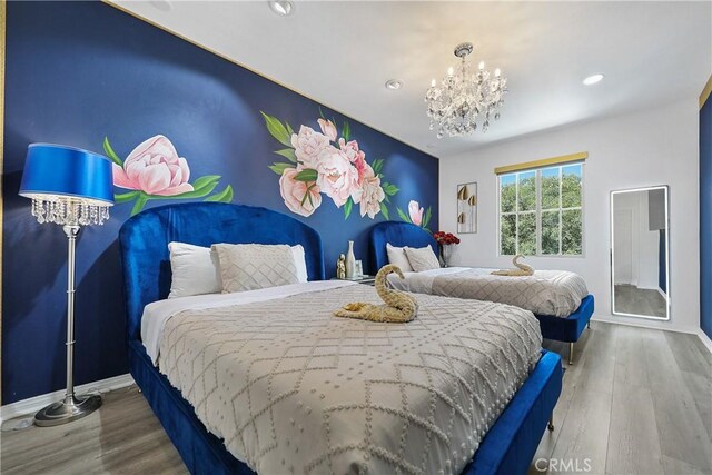 43228 Bacino Ct, Indio, CA 92203 - bedroom with a chandelier, recessed lighting, wood finished floors, and baseboards