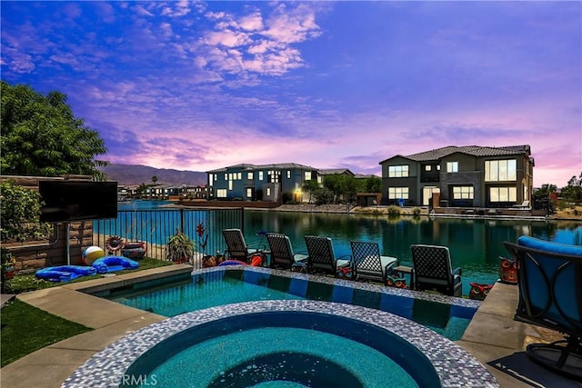 43228 Bacino Ct, Indio, CA 92203 - pool at dusk with a water view and a pool with connected hot tub