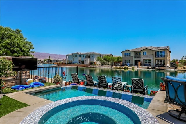 43228 Bacino Ct, Indio, CA 92203 - view of swimming pool with a water and mountain view, a pool with connected hot tub, and a residential view