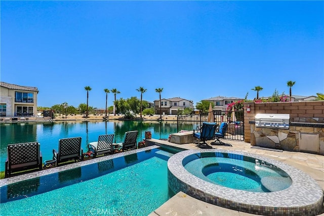 43228 Bacino Ct, Indio, CA 92203 - view of swimming pool with a pool with connected hot tub and a water view
