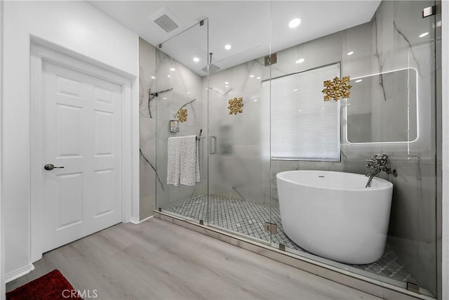 43228 Bacino Ct, Indio, CA 92203 - bathroom with wood finished floors, a marble finish shower, a freestanding tub, and recessed lighting