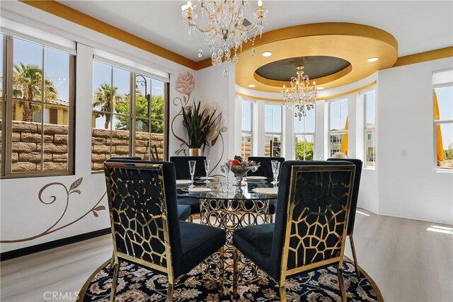 43228 Bacino Ct, Indio, CA 92203 - dining space featuring a chandelier, wood finished floors, and a raised ceiling