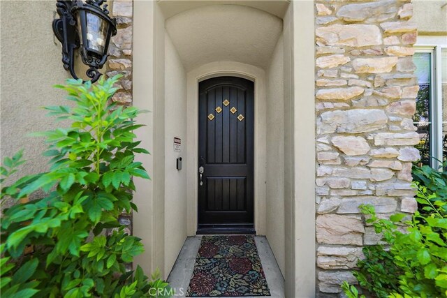 43228 Bacino Ct, Indio, CA 92203 - property entrance with stone siding and stucco siding