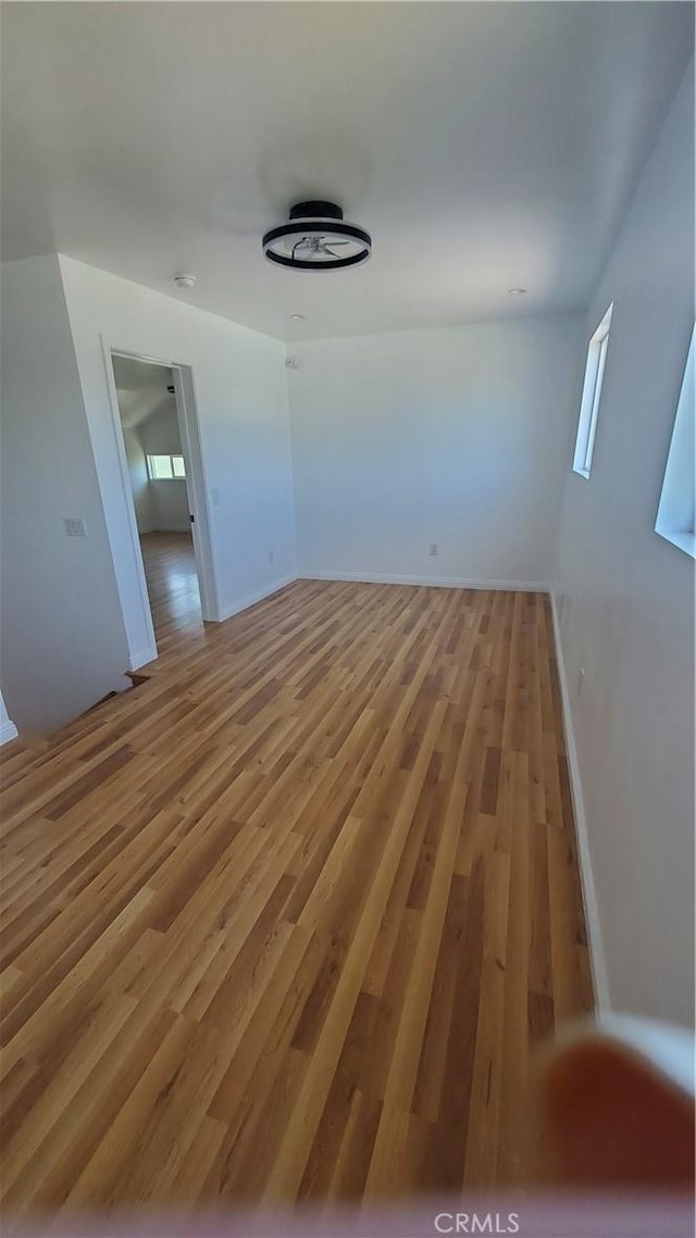 1330 W 48th St, Los Angeles, CA 90037 - spare room with light wood-style flooring, baseboards, and healthy amount of natural light