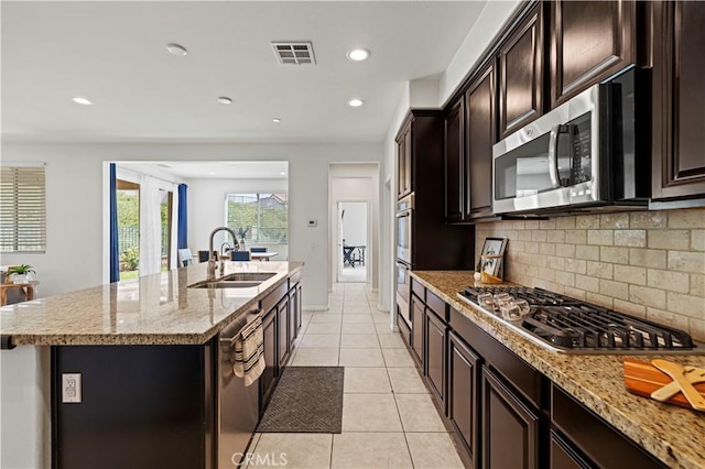 29015 Ridgecrest Ct, Valencia, CA 91354 - kitchen featuring a sink, stainless steel appliances, tasteful backsplash, an island with sink, and light tile patterned flooring