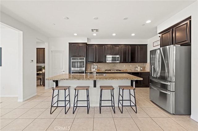 29015 Ridgecrest Ct, Valencia, CA 91354 - kitchen with stainless steel appliances, light tile patterned floors, decorative backsplash, a sink, and recessed lighting