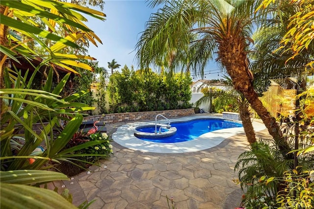 16561 Wanderer Ln, Huntington Beach, CA 92649 - view of swimming pool featuring a patio area, a fenced backyard, and a pool with connected hot tub