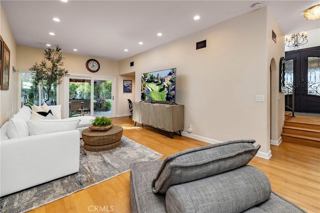 16561 Wanderer Ln, Huntington Beach, CA 92649 - living area with arched walkways, recessed lighting, light wood-type flooring, and baseboards