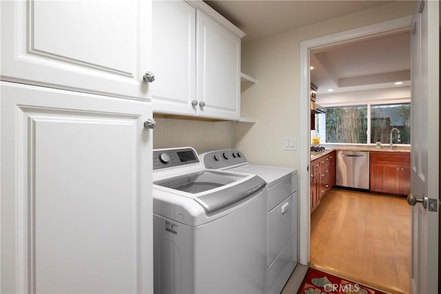 16561 Wanderer Ln, Huntington Beach, CA 92649 - laundry area with washer and dryer, cabinet space, light wood-type flooring, and recessed lighting
