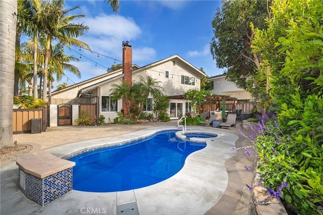 16561 Wanderer Ln, Huntington Beach, CA 92649 - view of pool featuring a patio, a gate, and a pool with connected hot tub