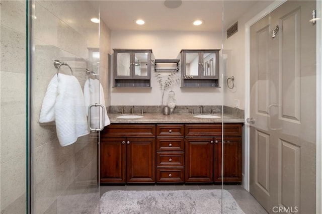 16561 Wanderer Ln, Huntington Beach, CA 92649 - bathroom featuring double vanity and a tile shower