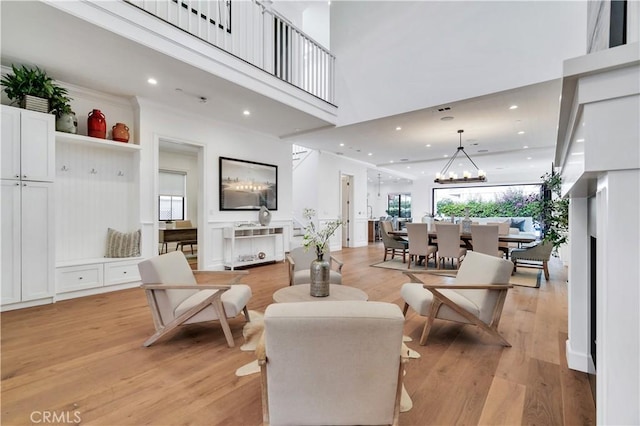 2001 Oak Ave, Manhattan Beach, CA 90266 - living room with light wood-style floors, a towering ceiling, a chandelier, and recessed lighting