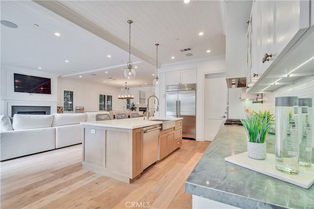 2001 Oak Ave, Manhattan Beach, CA 90266 - kitchen with stainless steel appliances, open floor plan, light wood-style floors, a fireplace, and ornamental molding