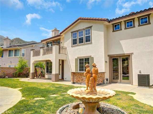 2237 Sageleaf Cir, Corona, CA 92882 - back of property with french doors, stucco siding, central AC unit, a chimney, and a balcony