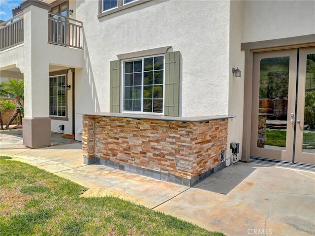 2237 Sageleaf Cir, Corona, CA 92882 - property entrance featuring french doors, a balcony, stucco siding, and a patio