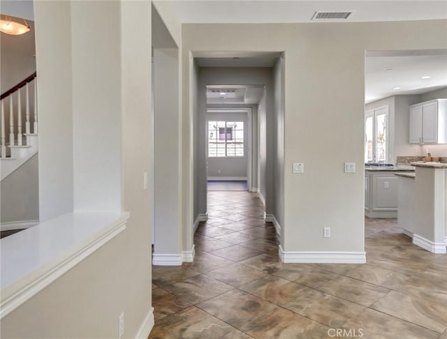 2237 Sageleaf Cir, Corona, CA 92882 - hall featuring plenty of natural light, baseboards, and stairway