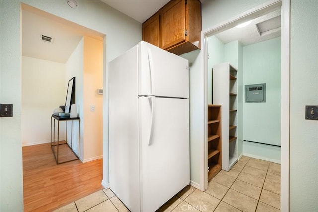 5631 Lake Park Way Unit 2, La Mesa, CA 91942 - kitchen with freestanding refrigerator, light tile patterned floors, brown cabinetry, and baseboards