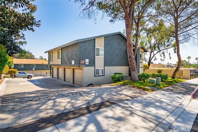 5631 Lake Park Way Unit 2, La Mesa, CA 91942 - view of front of property featuring concrete driveway, stucco siding, and a garage