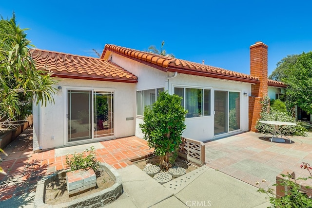 1702 Lark Tree Way, Hacienda Heights, CA 91745 - back of property featuring a patio area, stucco siding, and a tiled roof
