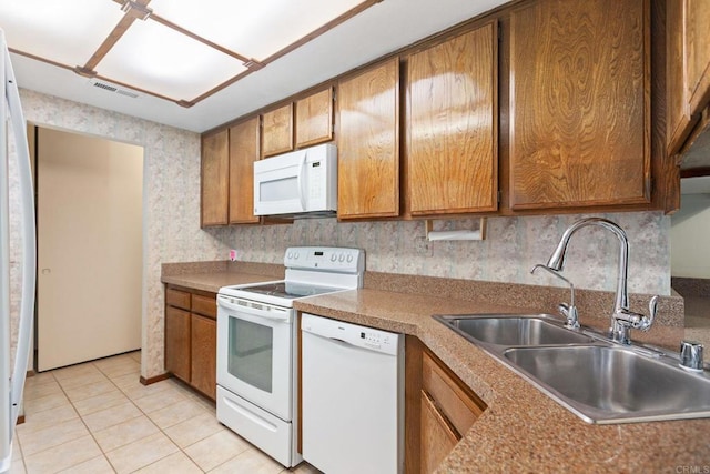 9336 Nalini Ct, Santee, CA 92071 - kitchen with white appliances, brown cabinets, light tile patterned floors, and wallpapered walls