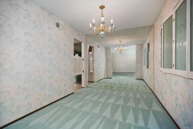 9336 Nalini Ct, Santee, CA 92071 - spare room featuring a chandelier, carpet, wallpapered walls, and a textured ceiling