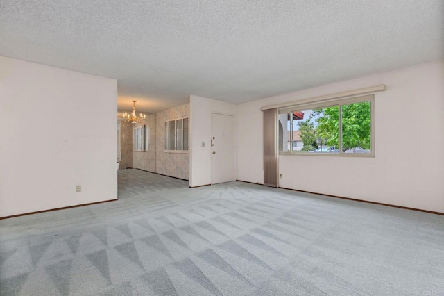 9336 Nalini Ct, Santee, CA 92071 - unfurnished living room with a chandelier, carpet flooring, and a textured ceiling